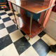 Elegant vintage serving trolley on wheels, two wooden shelves.