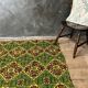 Green and yellow handmade rug with delicate colourful flowers