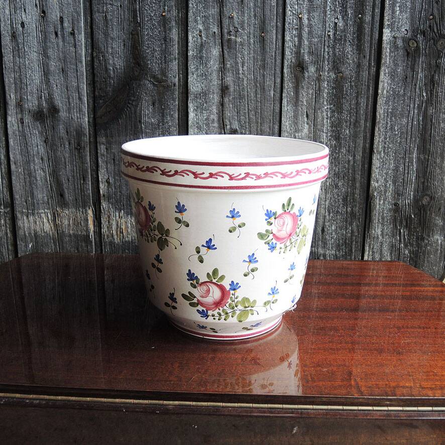 Vintage ceramic pot with hand-painted floral decoration.