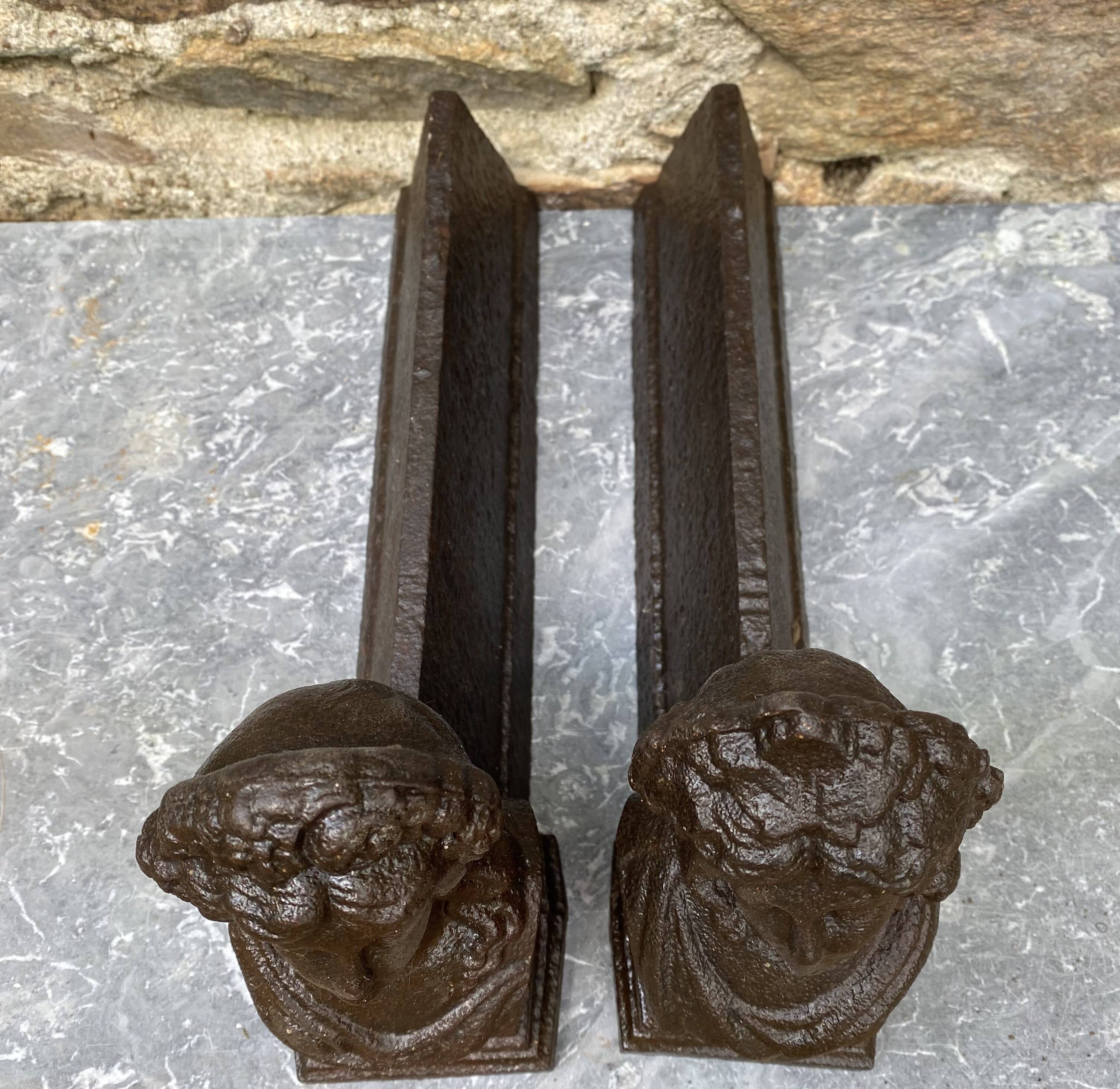 Paire de chenets anciens en fonte à bustes antiques