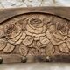 Wall-mounted coat rack in carved wood with rose decoration.