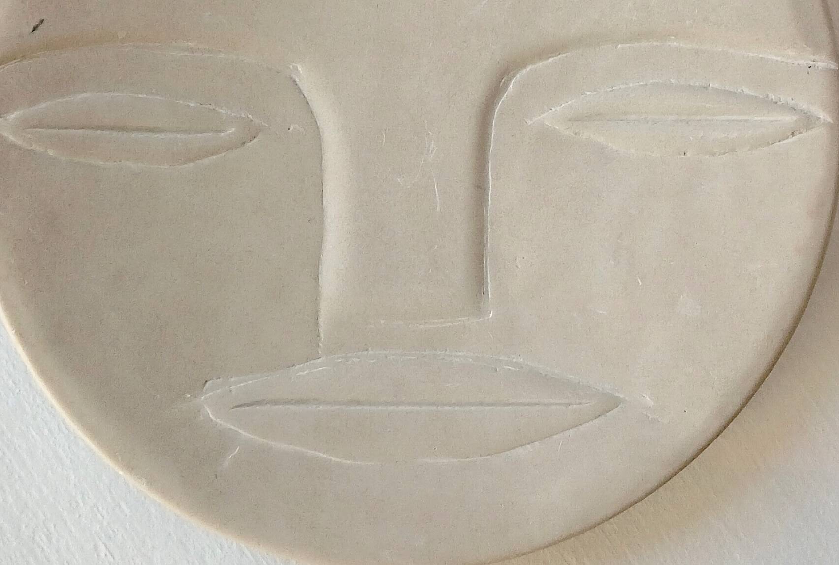 Plate "head with mask" natural stone hand carved