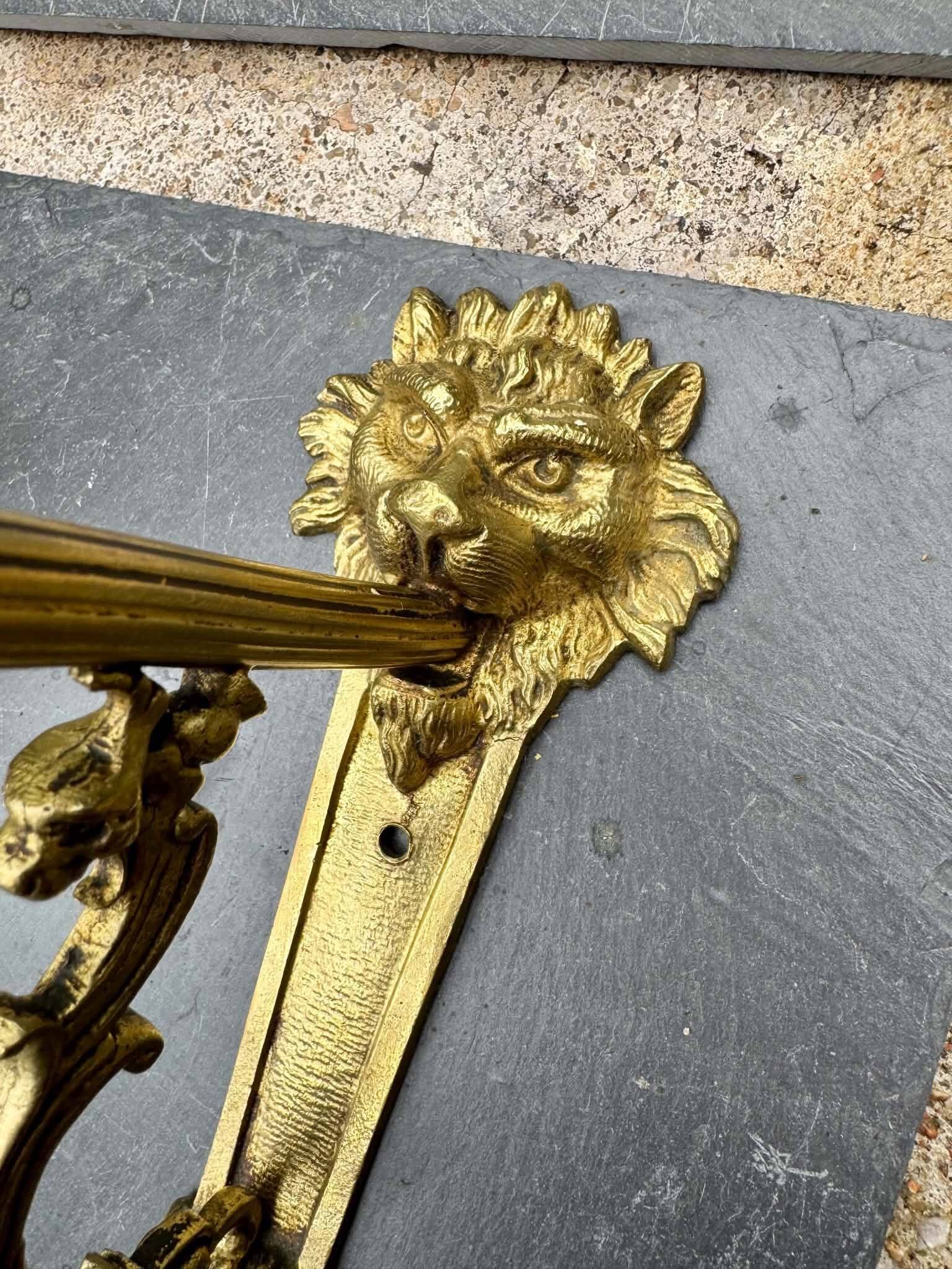 2 brass lion Empire wall sconces