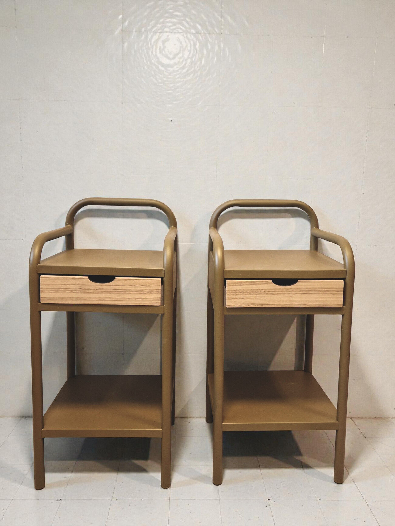 Old ochre metal bedside tables from a boarding school.