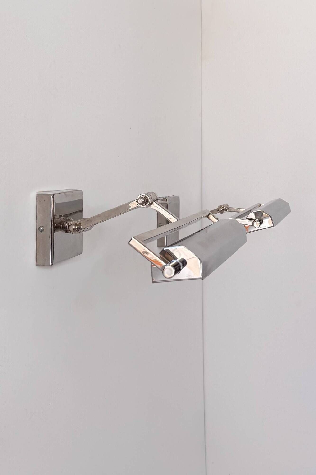 Pair of vintage geometric adjustable wall lights in chrome metal, France 70s.
