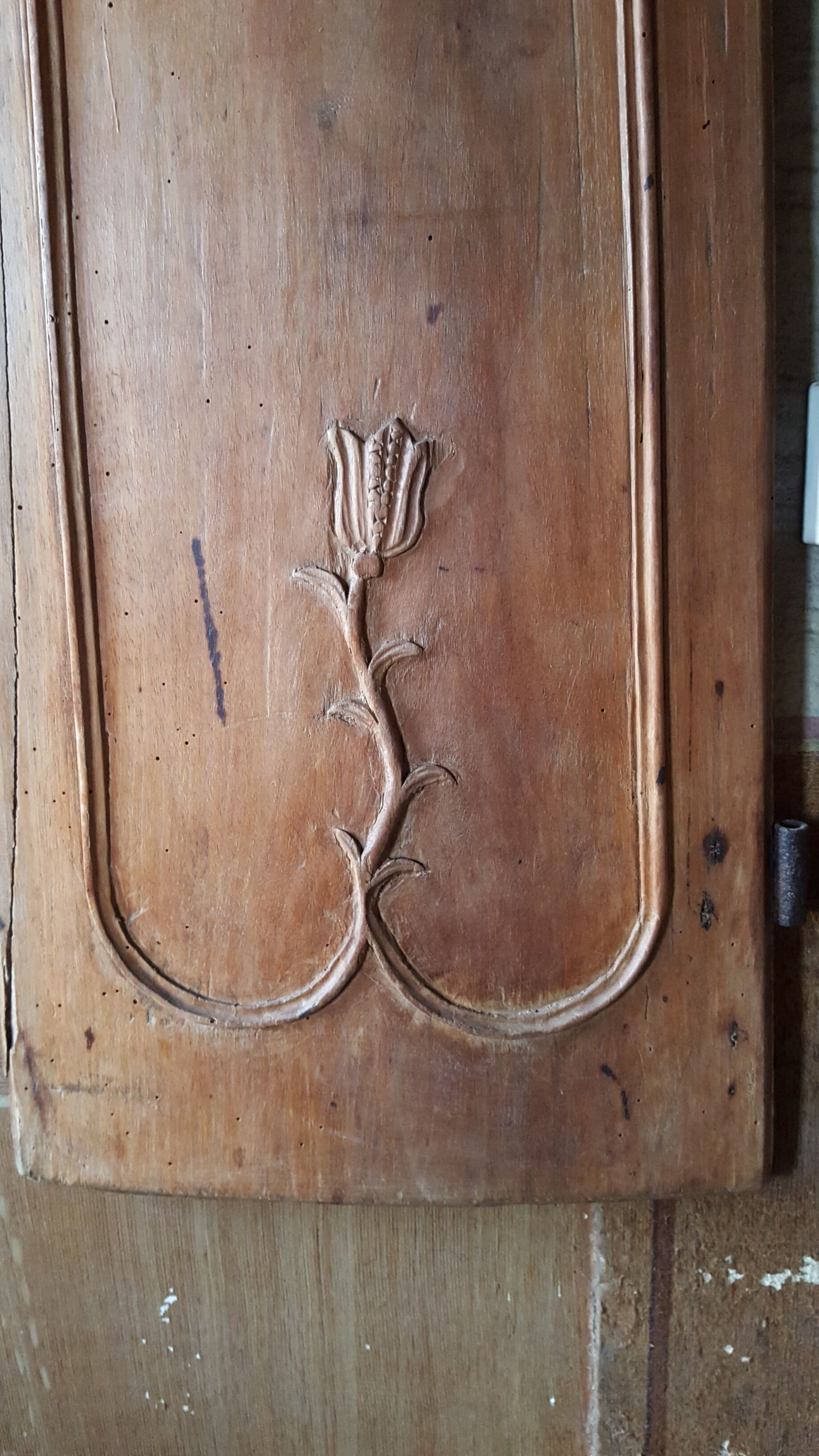 Wearing old 18th century decoration carved with flowers and foliage