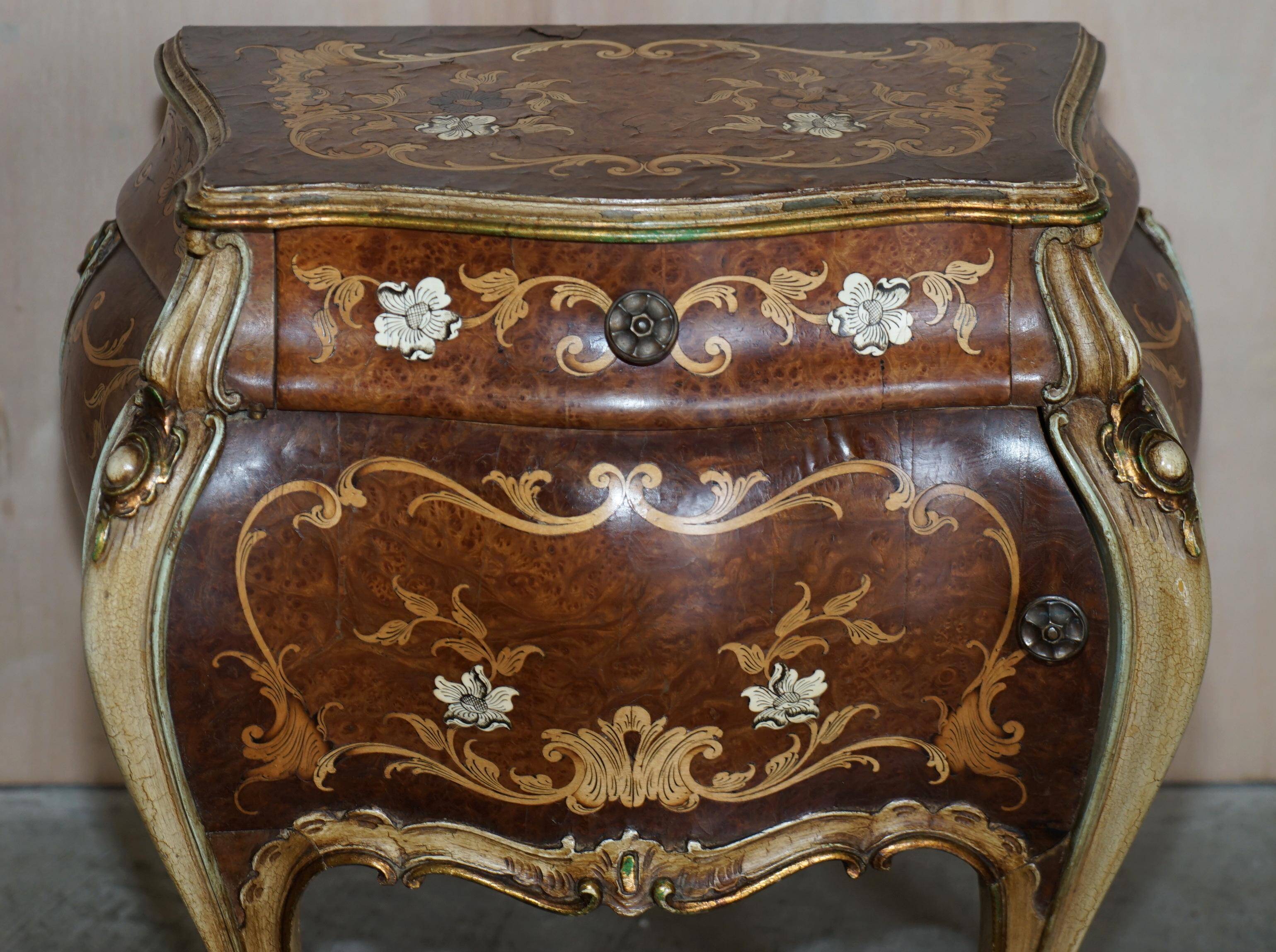 Pair of curved walnut commodes with marquetry and marble tops.