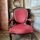 Napoleon III medallion armchair in carved wood and red velvet.