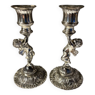 Two silver-plated metal candlesticks decorated with cherubs, 20th century