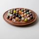 Vintage 1960s solitaire game, wooden board with stone marbles.