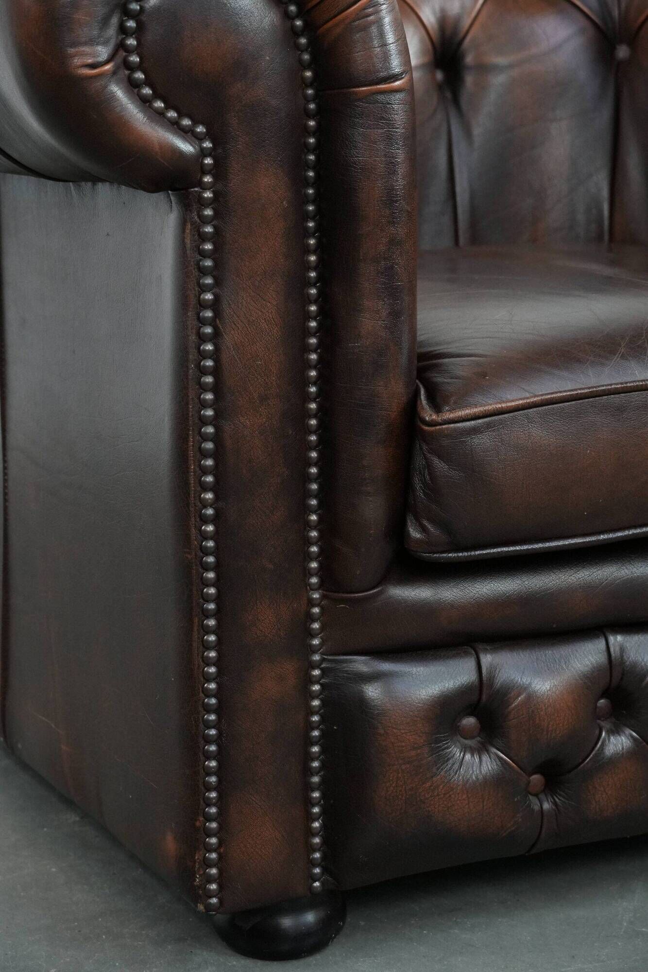 Brown Chesterfield armchair made of cowhide leather in English style