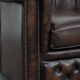 Brown Chesterfield armchair made of cowhide leather in English style