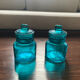Two small turquoise blue glass jars