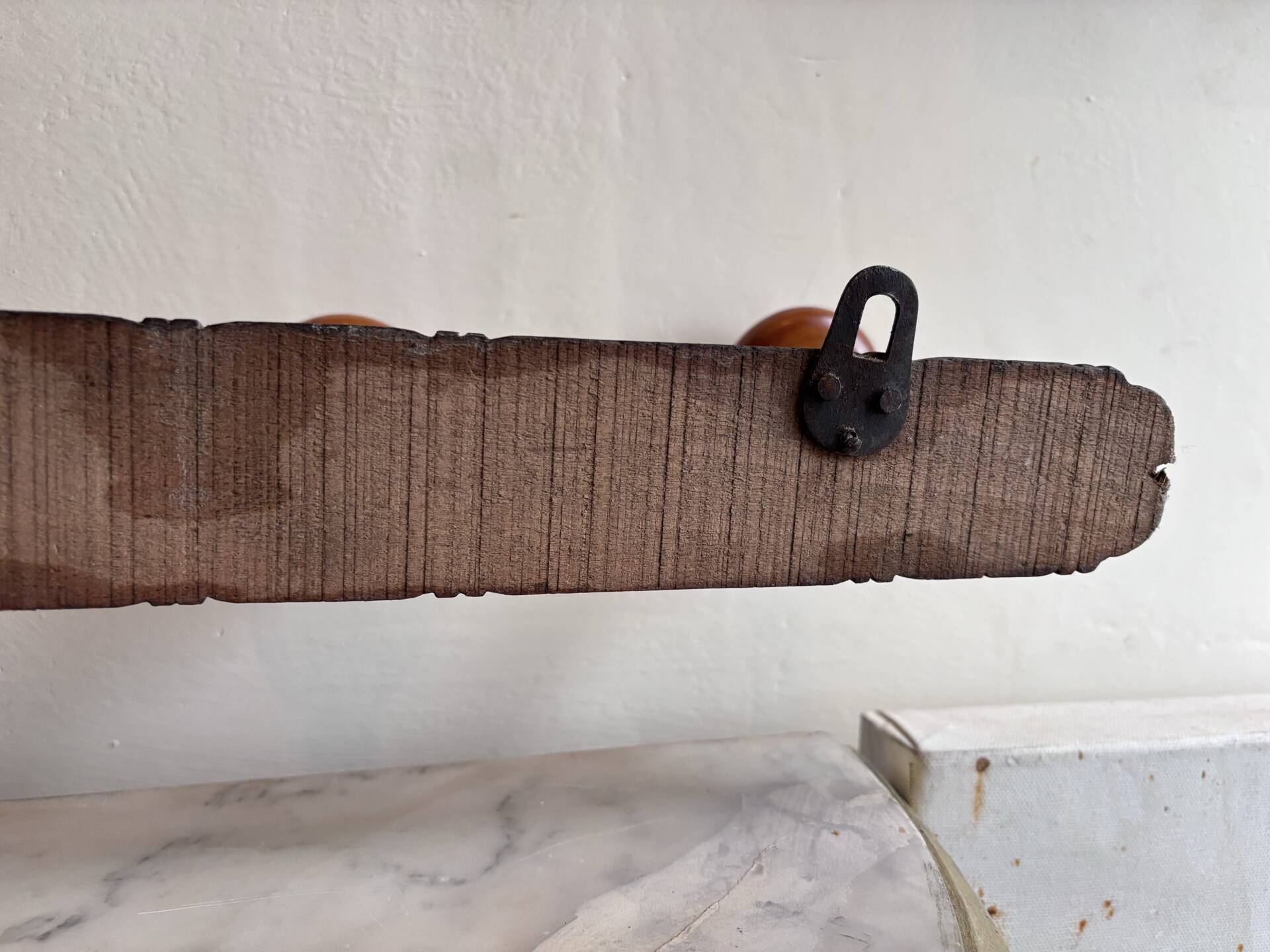 Wall-mounted coat rack with 8 turned wooden hooks in faux bamboo style.