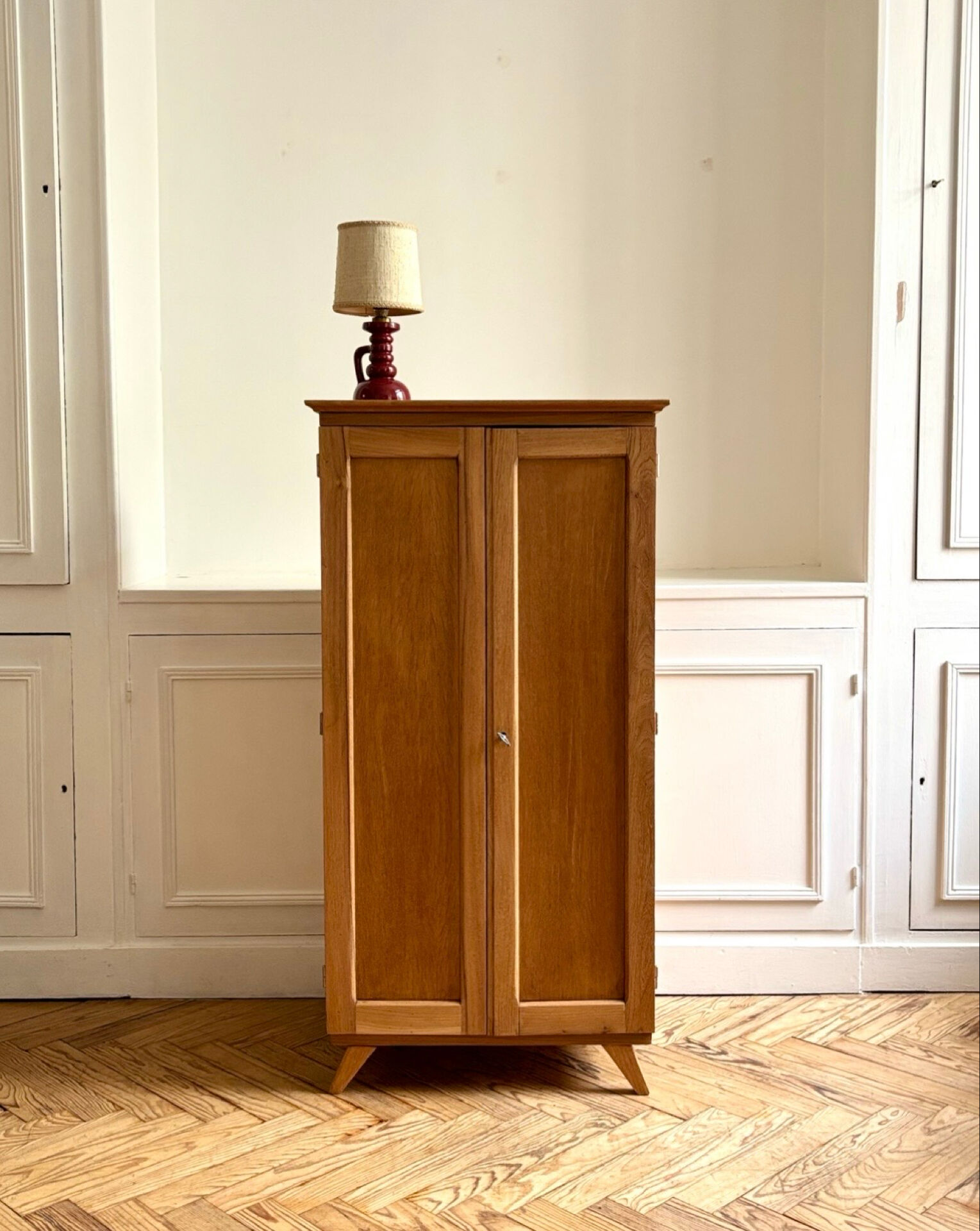 Small oak cabinet with tapered legs.