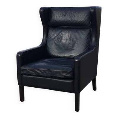 Fauteuil à oreilles scandinave vintage en cuir noir Lulu Stouby