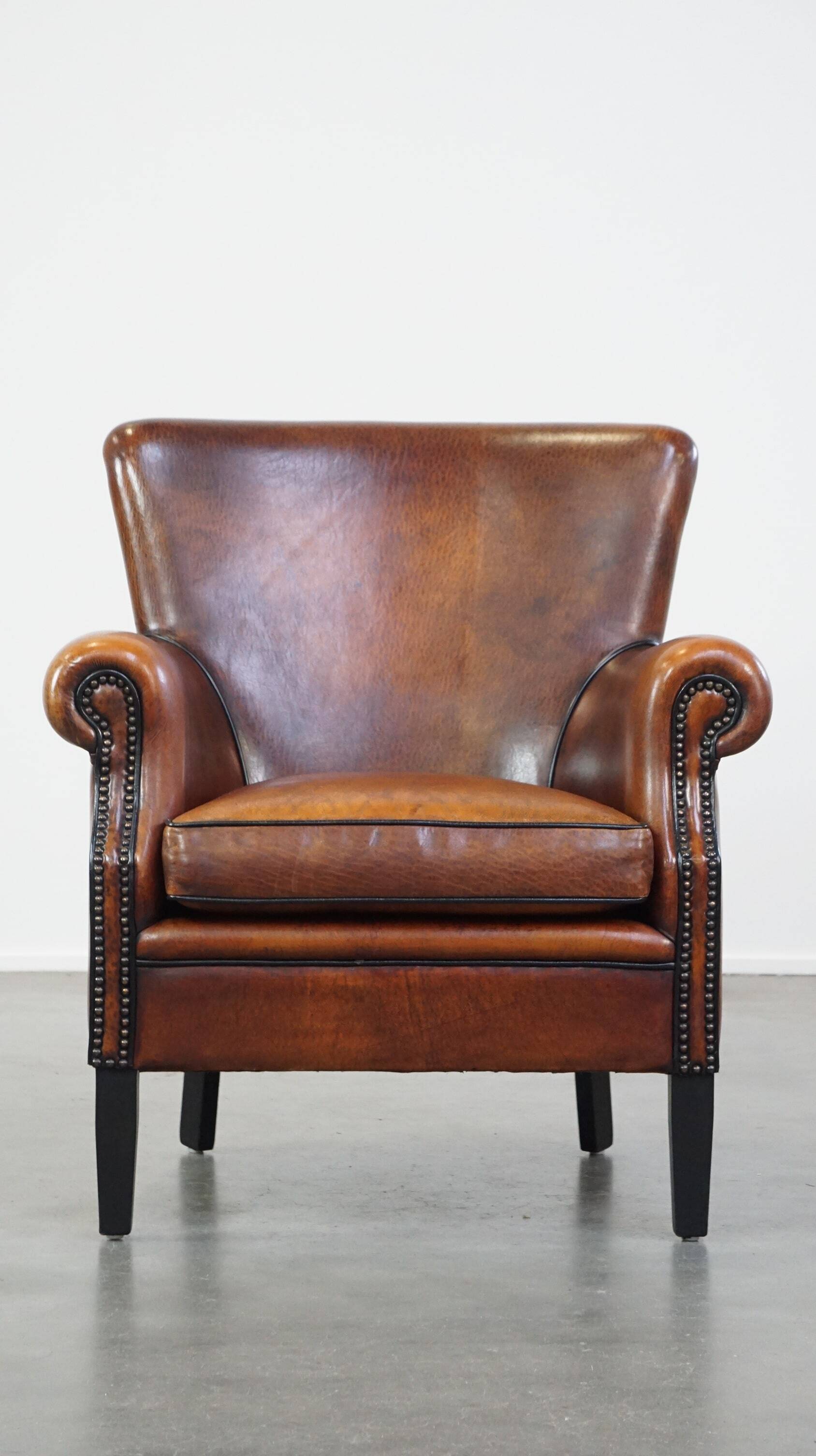 Sheepskin armchair/lounge chair finished with decorative nailheads