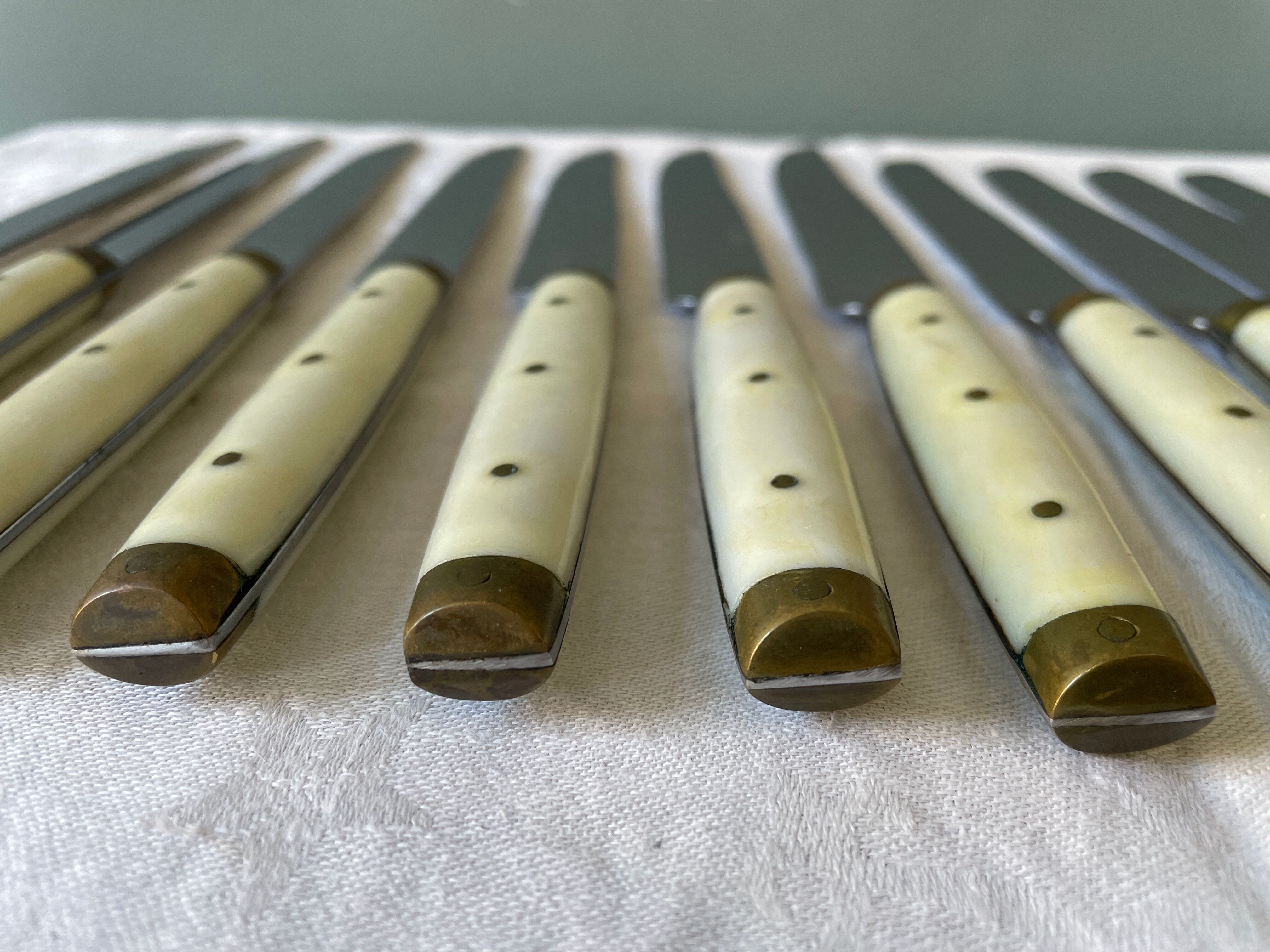 Series of 12 serrated vintage table knives