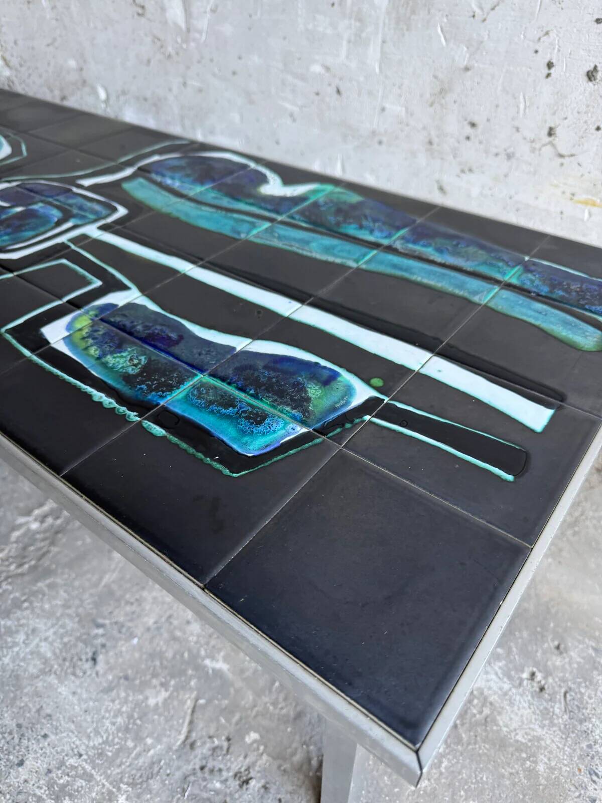 Mid-century Denisco ceramic coffee table — black, blue and white glazed tile top with silver metal base
