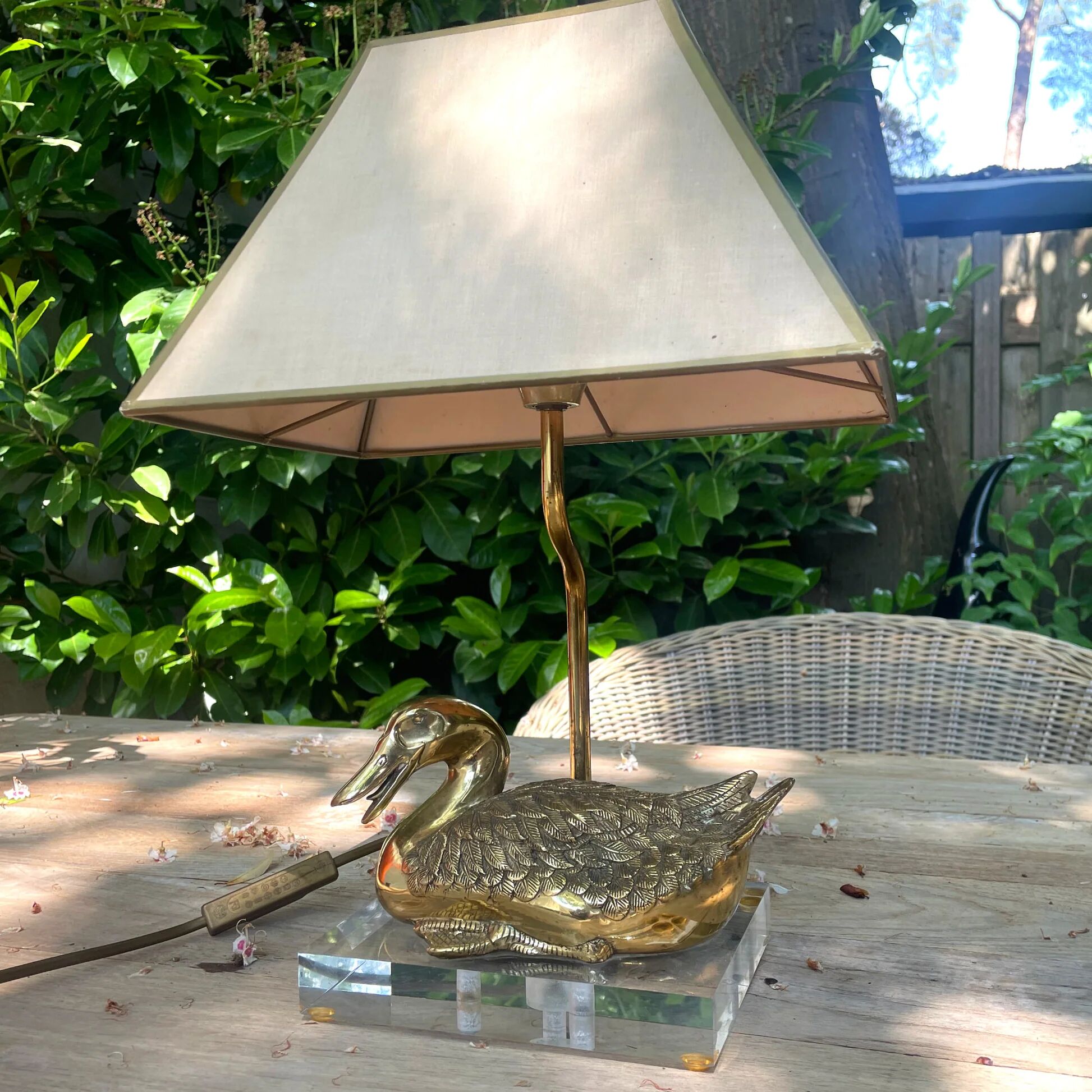Vintage brass table lamp in the shape of a duck from the 1970s on an acrylic base.