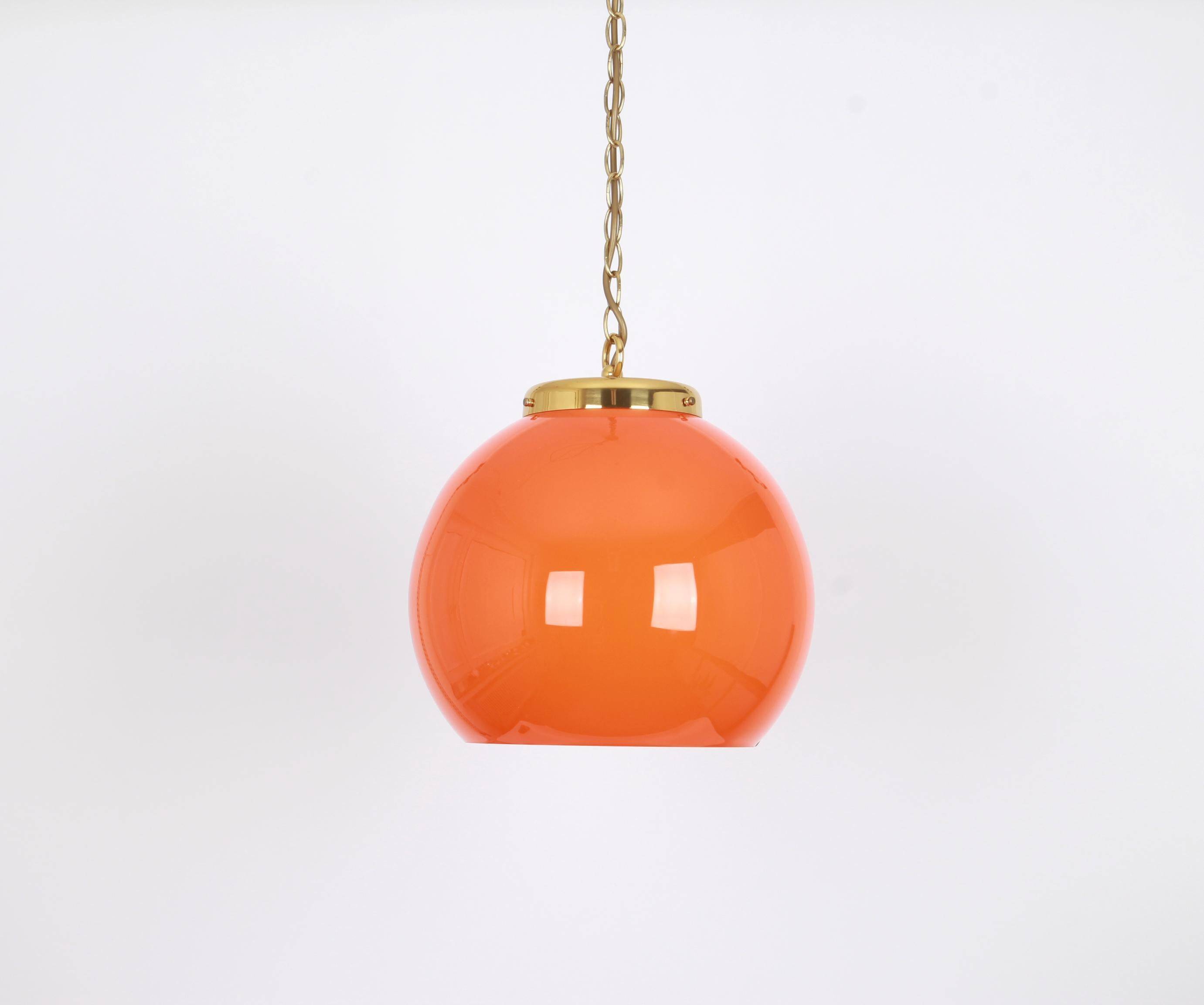 Orange glass pendant light by Peill Putzler, Germany, 1970.