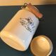 Enamelled milk jar retro style ecru color with "goose" patterns. Wooden handle.