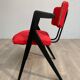 Red fabric chair with black base