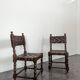 Pair of Spanish style chairs with leather straps.