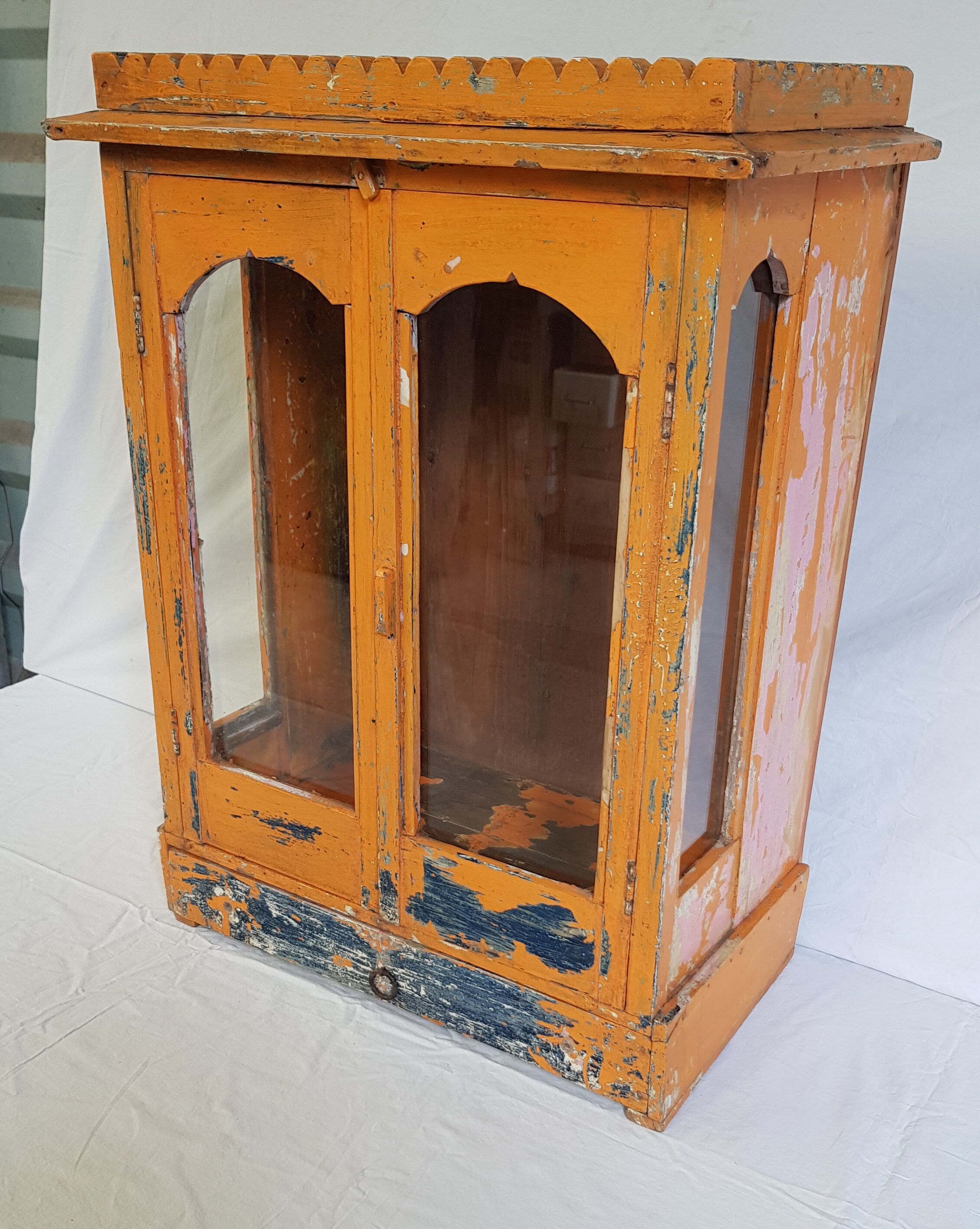 Old temple-showcase with teak offerings