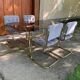 1970s table set with 4 chairs in gold brass and grey fabric, smoked glass top.