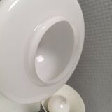 Small stylish table lamp with perforations and milky white opal glass shade
