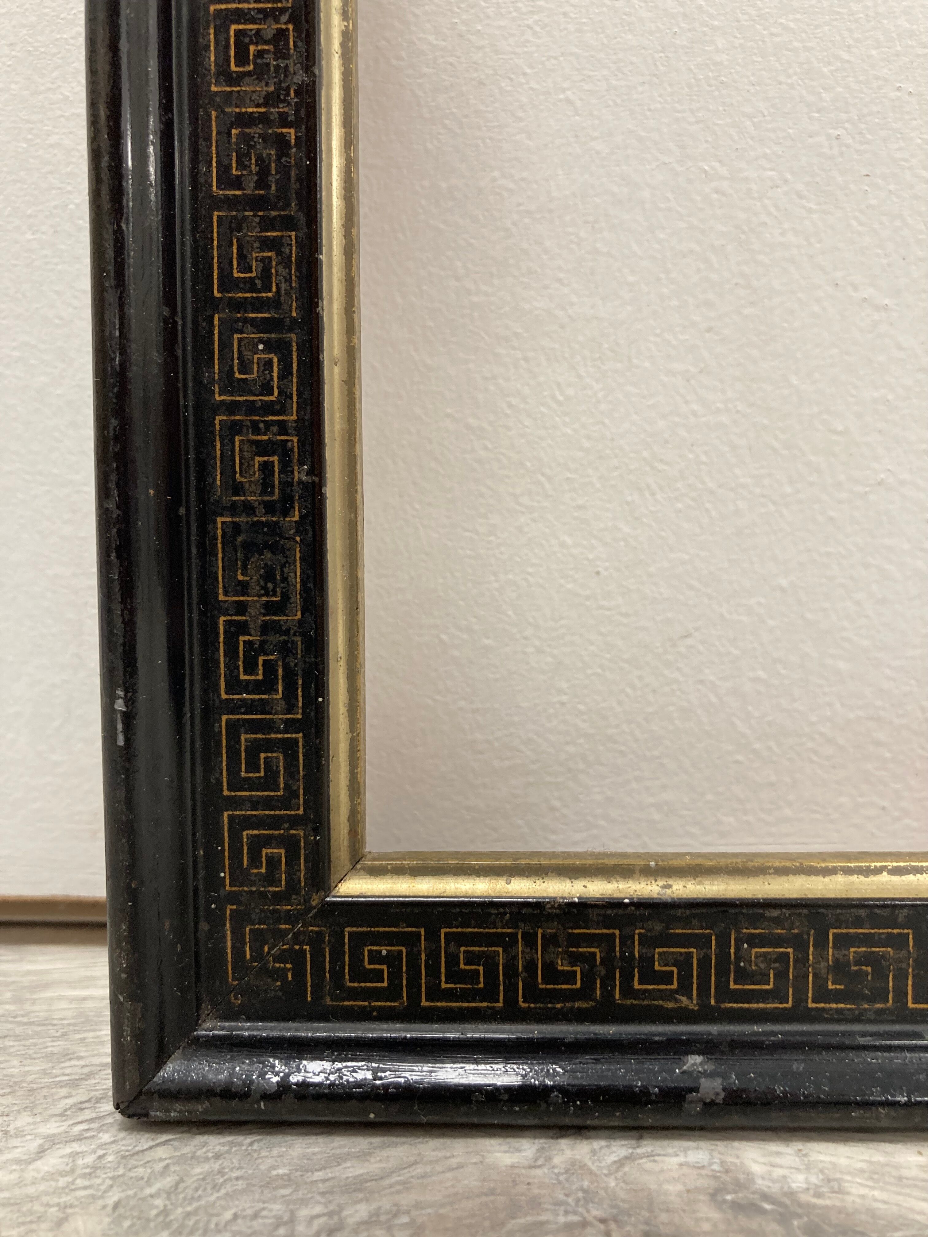 Black and gold frame decorated with Greek frieze decoration