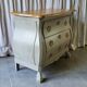 Curved patinated chest of drawers