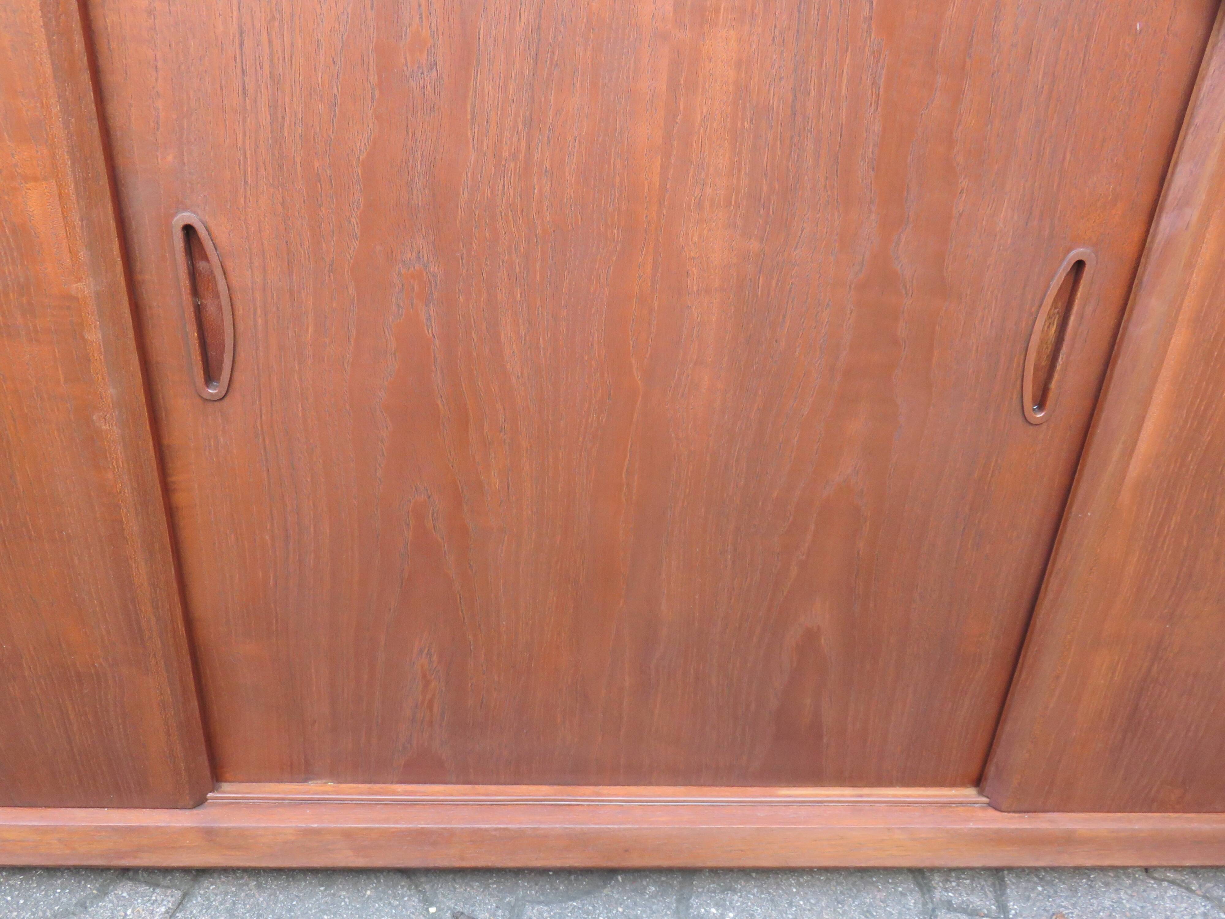 Low sideboard with 3 sliding doors in teak. Denmark 1960