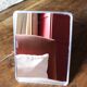 Simple rectangular barber mirror with a stand.