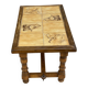 Vintage 70s coffee table with wood and ceramic tiles featuring bird and nature patterns.