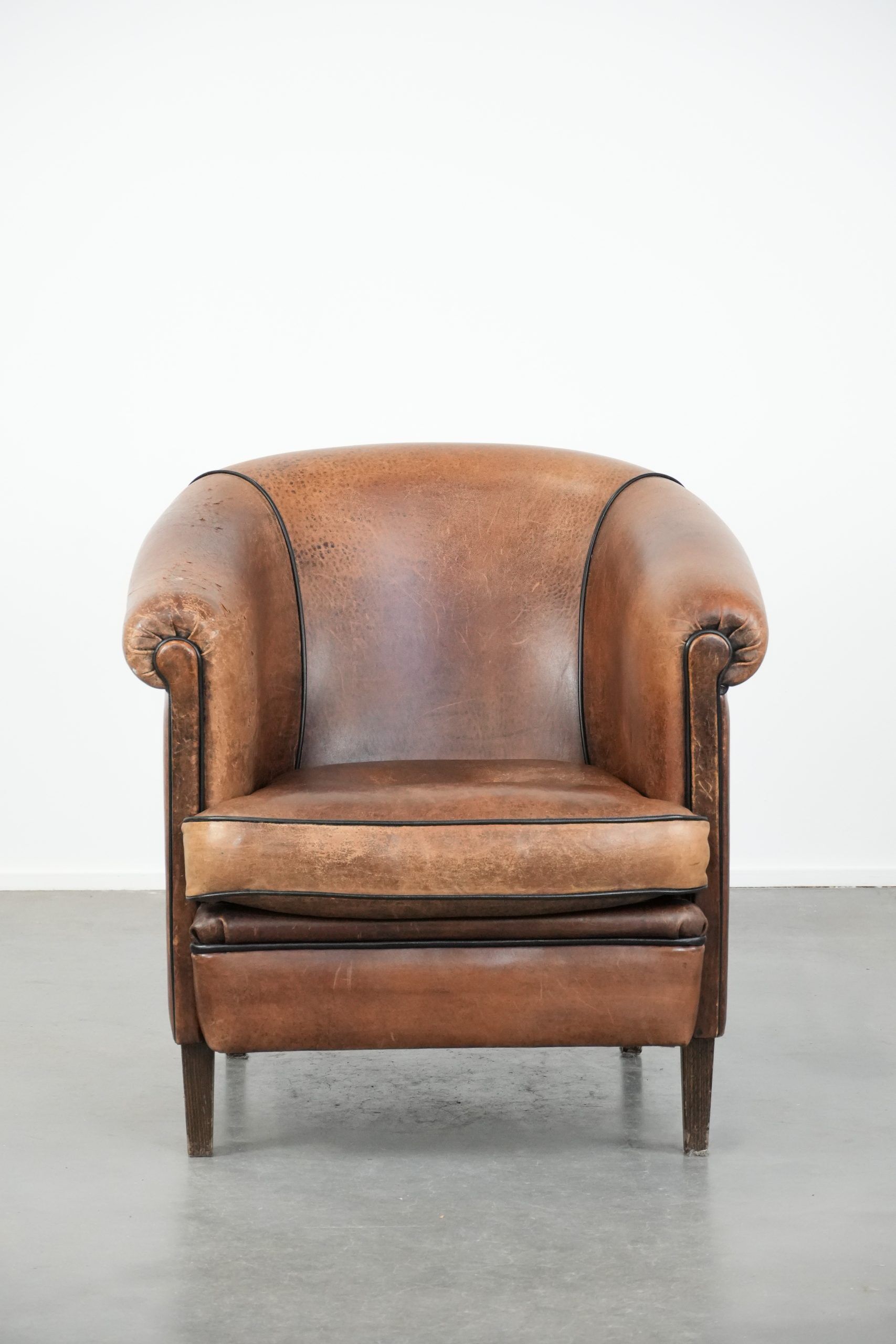 Sturdy vintage sheepskin club armchair with a beautiful patina