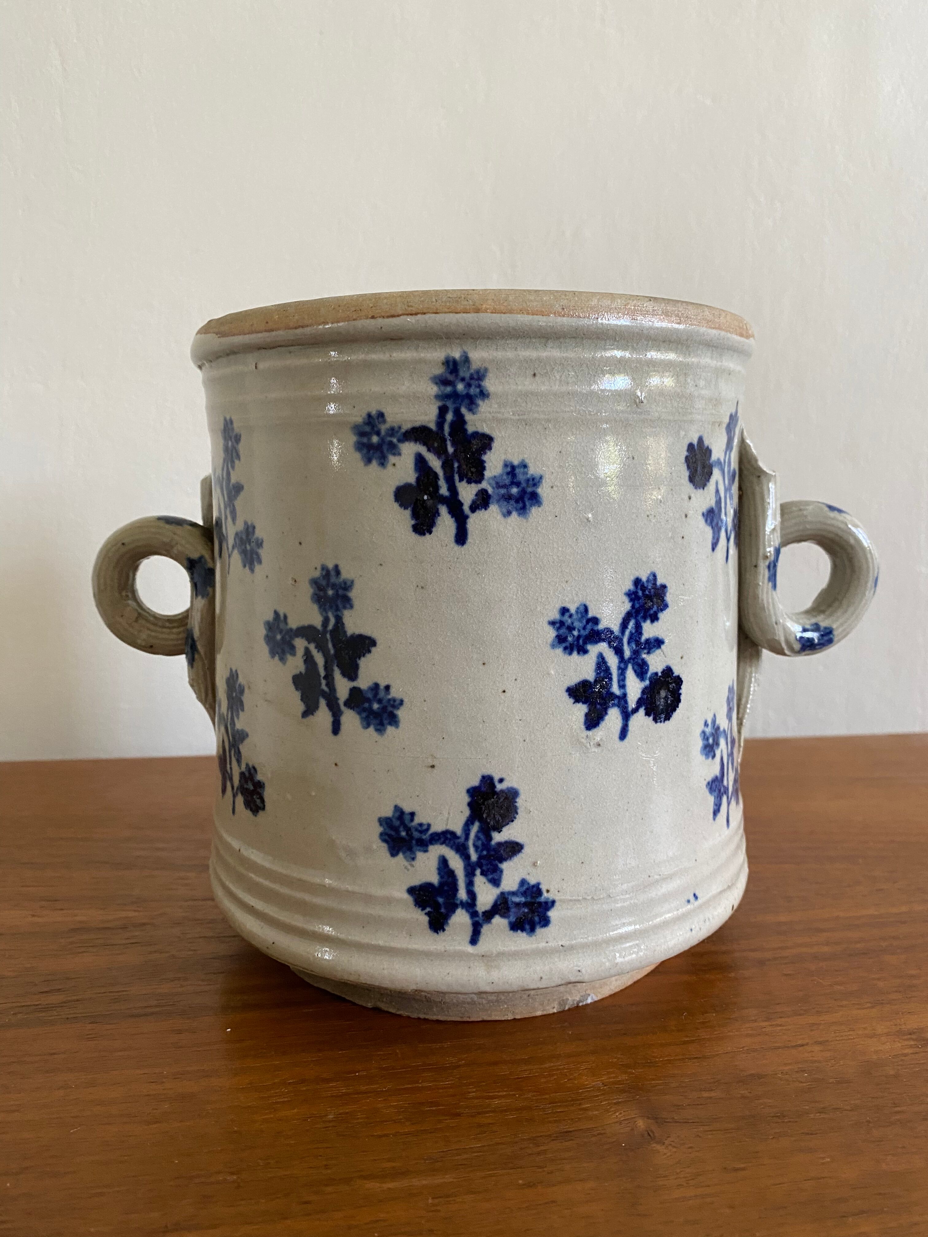Old pot, sandstone, blue flower decoration