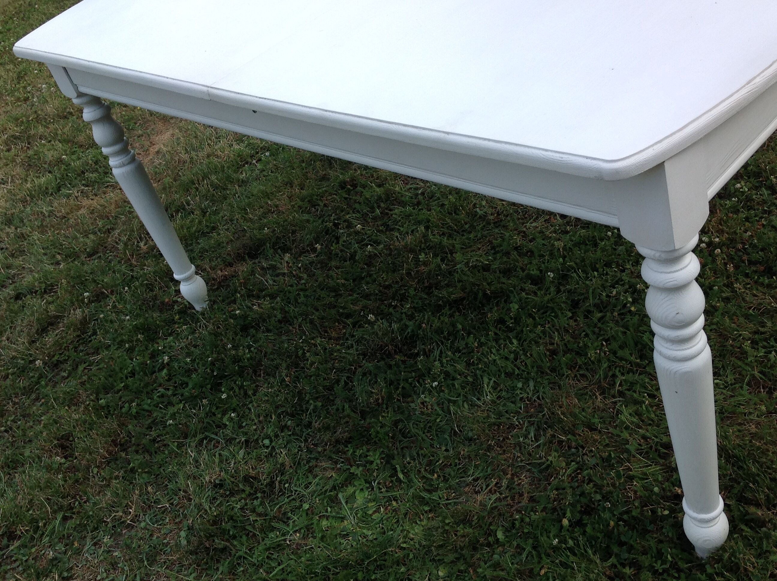 White farmhouse table set and four chairs
