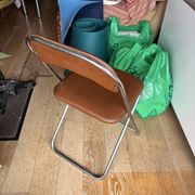 Brown folding chair in vinyl and steel