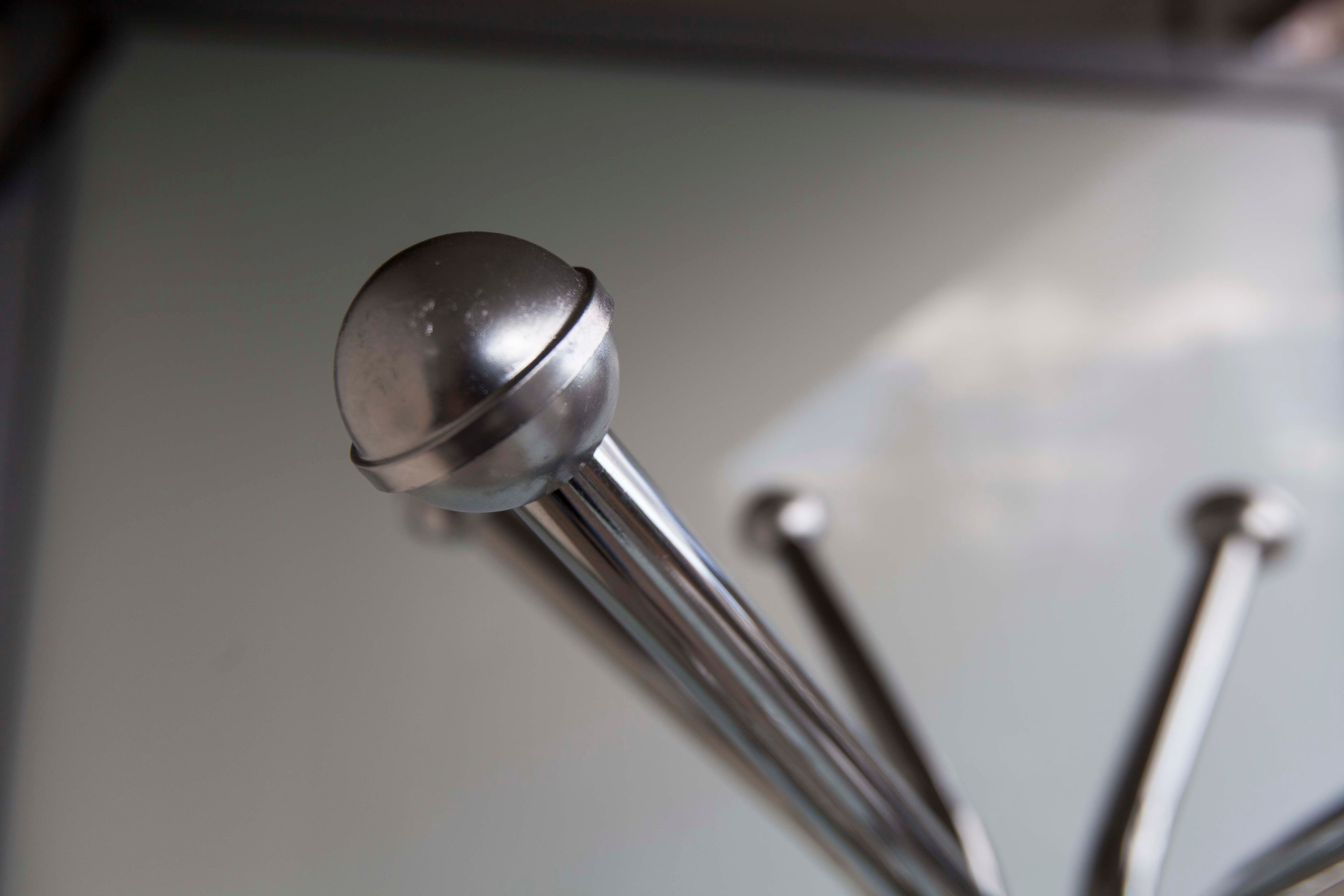 Chrome metal parrot coat holder from the 70s