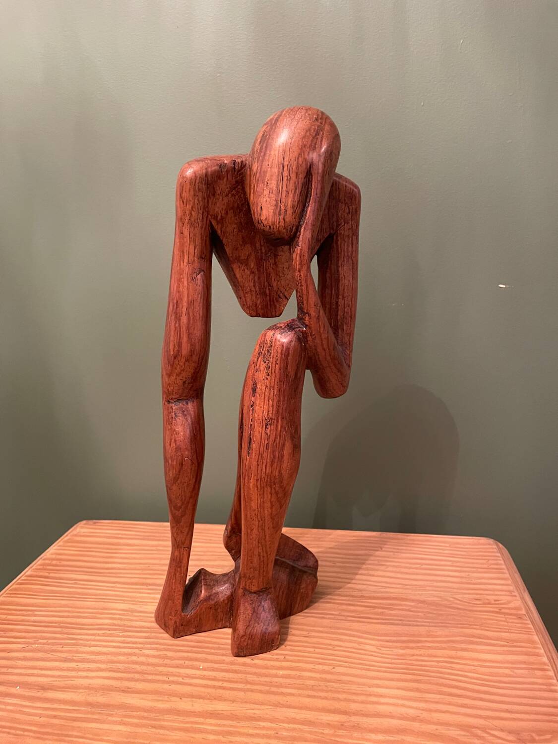 Wooden sculpture inspired by Rodin's "The Thinker"