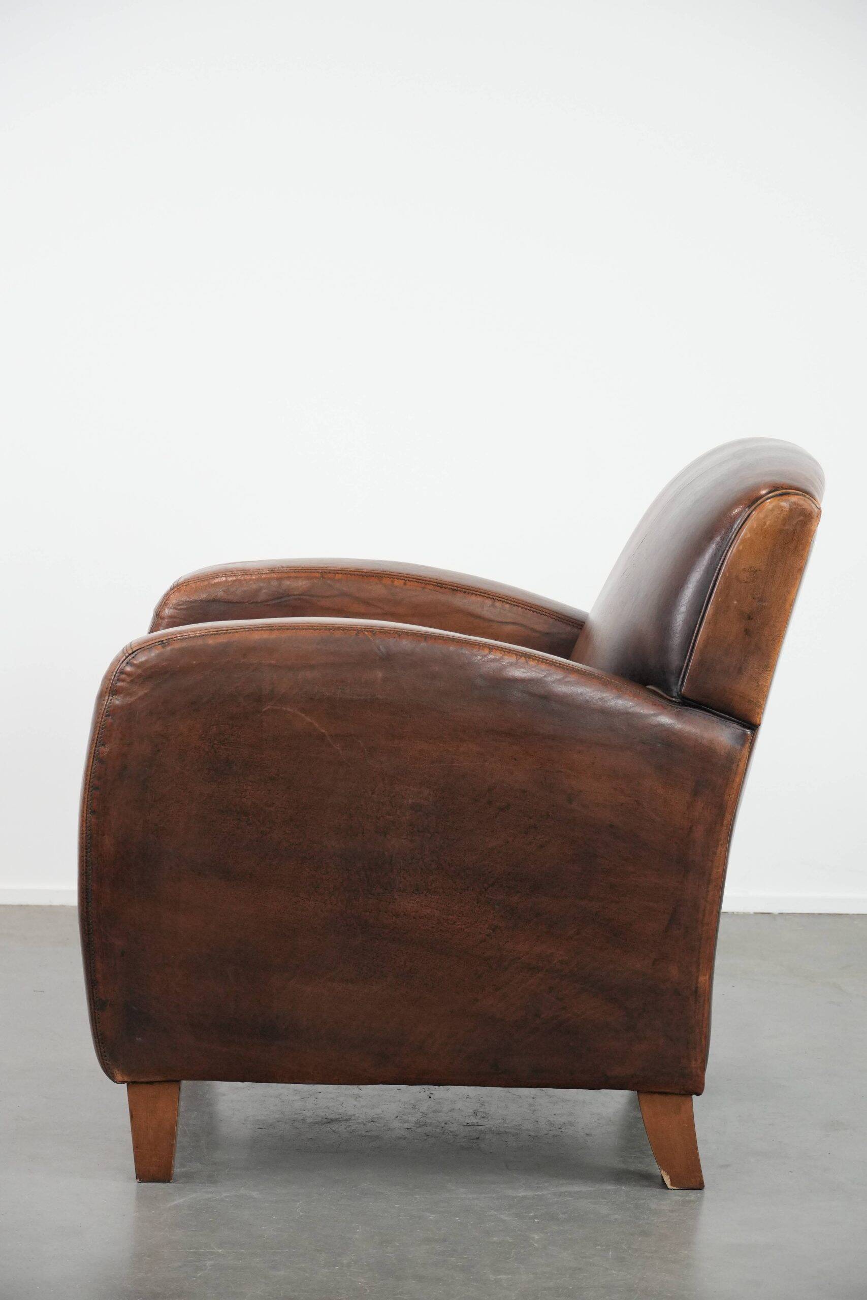 Beautifully shaped vintage sheepskin armchair with character