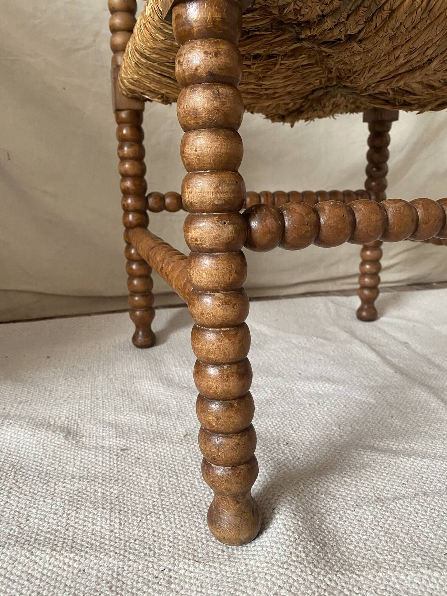 Corner chair in straw and turned wood, fireside chair.