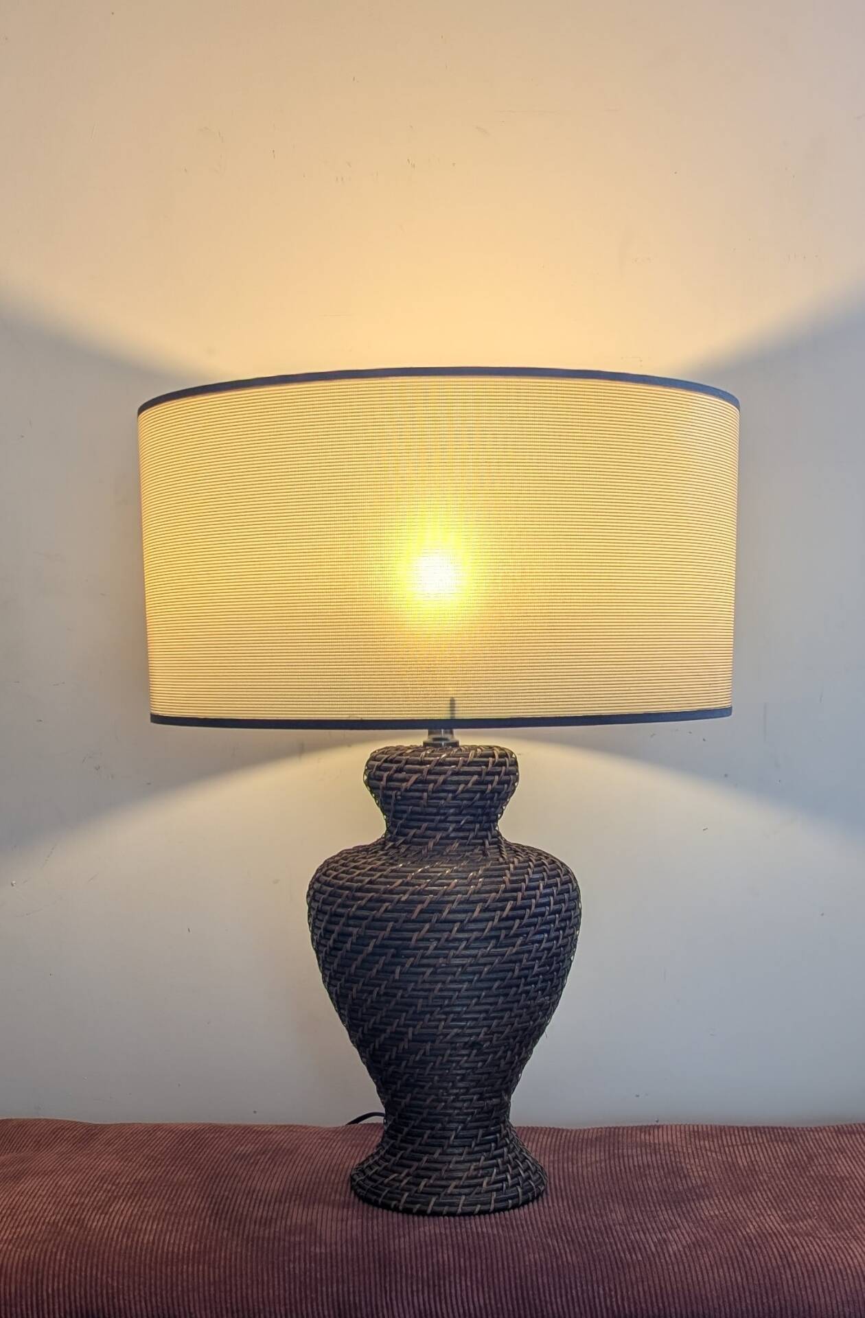 Vintage lamp in brown rattan with textured lampshade.