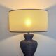 Vintage lamp in brown rattan with textured lampshade.