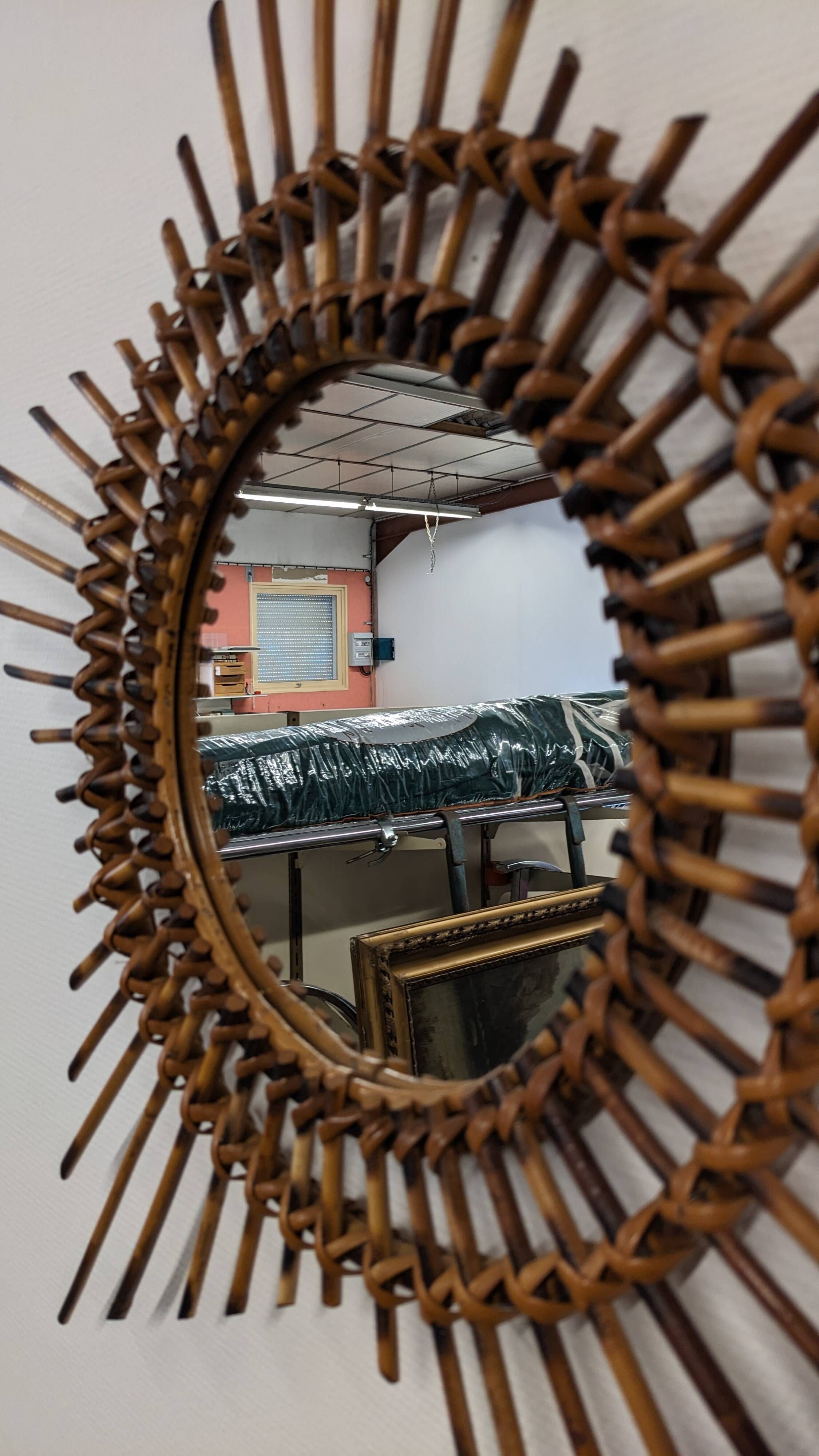 Starry sun mirror in rattan, France around 1960.