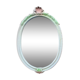 Vintage oval mirror in carved wood in pastel tones