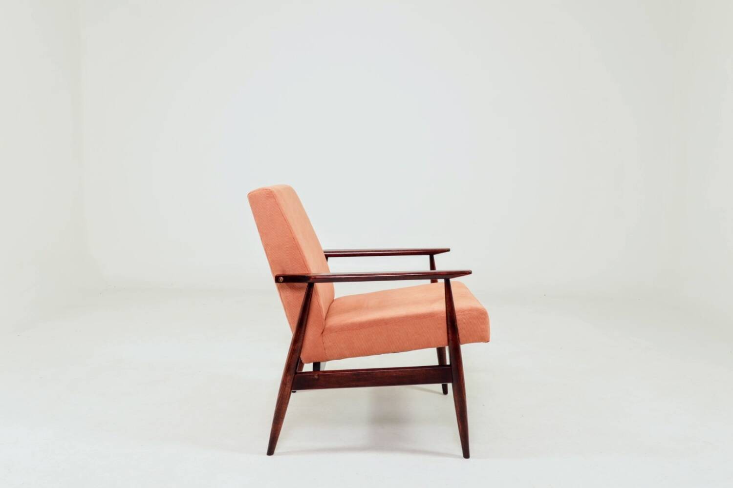 Mid-century modern armchair in coral red designed by H. Lis.