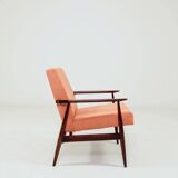 Mid-century modern armchair in coral red designed by H. Lis.